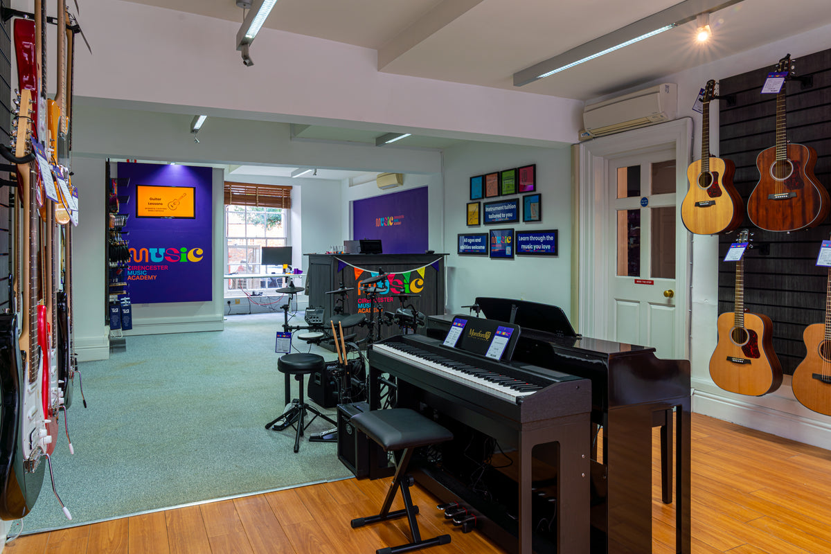 Digital pianos and guitars displayed inside Cirencester Music Academy