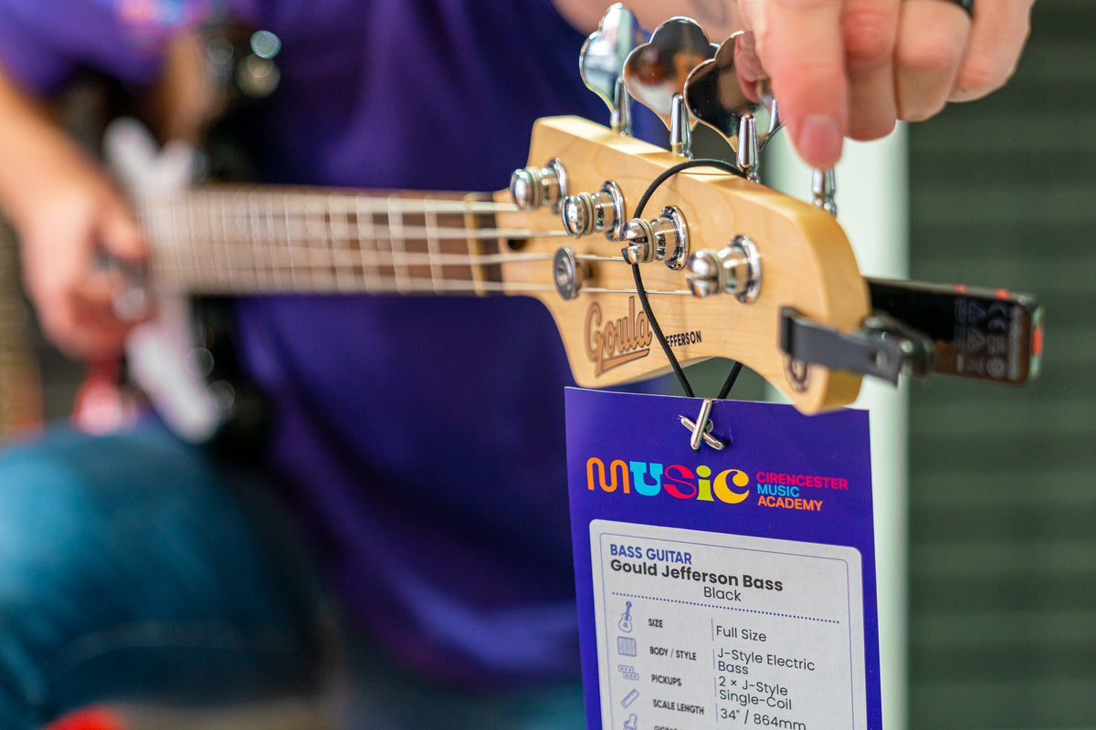 Tuning the headstock of a bass guitar in the Cirencester Music Academy shop