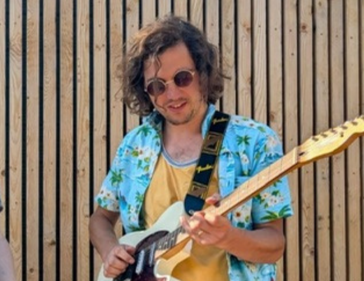 Colin playing electric guitar outdoors